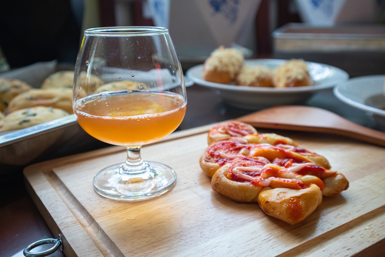orange wine with doughy cake on a wooden serving dish